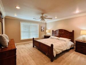 a bedroom with a bed and a ceiling fan at 5-Bedroom Home to Texoma lake and Casino in Durant +33 photos