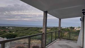 a balcony with a view of the ocean at IZAVA LODGE in Rodrigues Island