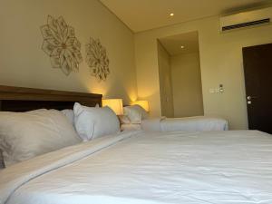 Giường trong phòng chung tại Mimosa
