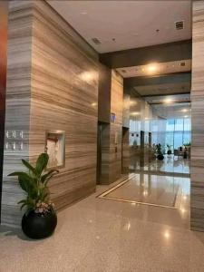 a lobby with a potted plant in a building at LUXURY CONDO STUDIO UNIT at 38 PARK AVENUE CEBU I T PARK in Tabok +31 photos