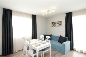 a living room with a blue couch and a table at Sofia Top Apartments in Sofia