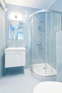 a bathroom with a shower and a toilet and a sink at Sofia Top Apartments in Sofia