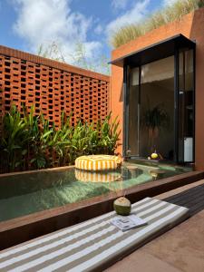 a swimming pool in the backyard of a house at Kula Terra One Bedroom Villa in Kerobokan
