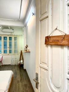 a room with a door with a sign on it at Sora Home - 3 mins to Hoan Kiem Lake in Hanoi