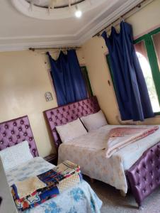 Postel nebo postele na pokoji v ubytování hôtel oasis tinghir