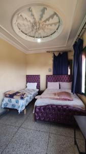 Postel nebo postele na pokoji v ubytování hôtel oasis tinghir