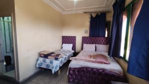 Postel nebo postele na pokoji v ubytování hôtel oasis tinghir