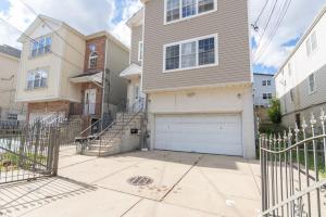 a house with a white garage door on a street at 4 Bedroom-Airport Convient in University of Medicine and Dentistry Rooftop Heliport