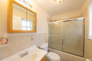 a bathroom with a shower and a toilet and a sink at 4 Bedroom-Airport Convient in University of Medicine and Dentistry Rooftop Heliport +19 photos