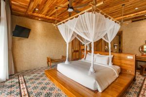 a bedroom with a bed with a mosquito net at Grand Ocean Bay Resort Phu Quoc in Phu Quoc +72 photos