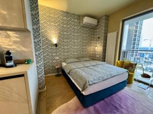 a bedroom with a bed and a large window at BW Dandyland - Love Tree in Belgrade