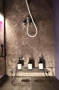 two bottles on a rack in a bathroom with a shower at BW Dandyland - Love Tree in Belgrade