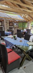 an outdoor patio with a table and chairs at Etno selo Dukat in Belo Polje