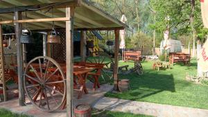a picnic table and a cart in a yard at Etno selo Dukat in Belo Polje +17 photos