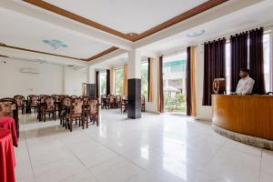 a man standing at a podium in a room with chairs at Ranthambore Resort in Sawāi Mādhopur