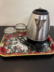 a tea pot and glasses on a tray with a table at Sudama ki Kuttiyaa in Ayodhya +16 photos