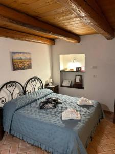 a bedroom with a bed with two towels on it at Al Castello in Tavullia