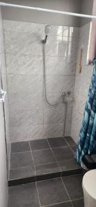 a shower with a shower head in a bathroom at Sweet Candy Studio Apartment in Julianadorp +6 photos