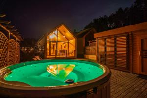 a jacuzzi tub in the backyard of a house at Bursztynowo Kąty Rybackie in Kąty Rybackie