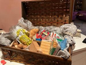 a basket filled with different types of food on a table at Stillness Valley - La Casa nella Valle della Quiete in San Mauro Torinese