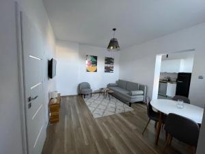 a living room with a couch and a table at Apartament Nowomiejska in Wałcz