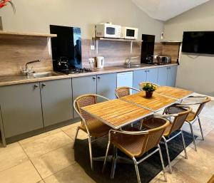 a kitchen with a table and chairs and a kitchen with a sink at Private Heated Bedrooms at The Bunkhouse in Snowdonia Perfect for Bikers and Walkers in Dolgellau
