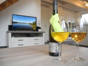 a bottle of wine and two wine glasses on a table at Vechteperle - Nordhorn in Nordhorn