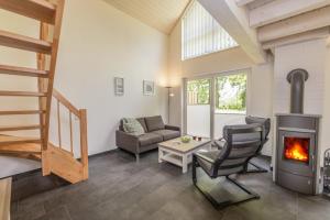 a living room with a wood stove and a couch at Lee - Nordhorn in Nordhorn