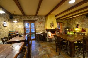 a dining room with wooden tables and chairs and a fireplace at Helydorea zen BED& BREAKFAST in Synikia Mesi Trikalon