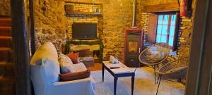 a living room with a couch and a tv at CASA DEL CURA in Molleda