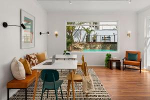 a living room with a white table and chairs at Neighbourgood Ravenscraig in Cape Town