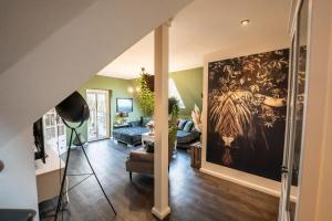 a living room with a large painting on the wall at Landglück - Nordhorn in Nordhorn