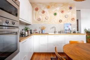 a kitchen with a table and a wooden wall at Chambre chez l'habitant - Arty & Élégante - SDB privée in Nantes