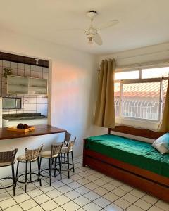 a bedroom with a bed and a table and chairs at Sol-datelli Apês Floripa in Florianópolis