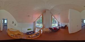 a living room with a large archway in a house at Ferienhaus Haus am See - Nordhorn in Nordhorn
