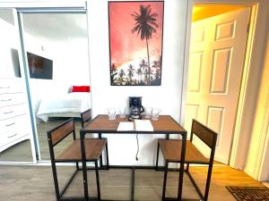 a dining room with a table and two chairs at Superior beach studio with Pool Access and free parking in Daytona Beach