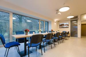 a conference room with a long table and chairs at Vila Vivenot in Malá Morávka
