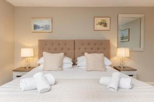 Un dormitorio con una gran cama blanca con dos lámparas. en Lovely Georgian Loft in The Very Centre of Bath, en Bath