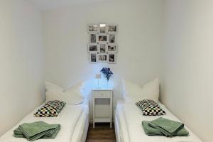 a room with two beds and a table with a lamp at Ferienhaus Felix am Radweg im Naturschutzgebiet in Templin