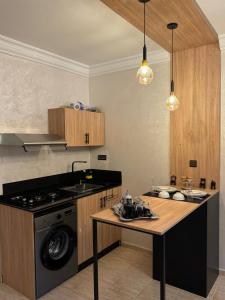 a kitchen with a stove and a counter top at Atlas appartement in Fez