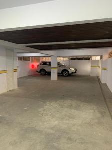 a parking garage with a car parked in it at Sol-datelli Apês Floripa in Florianópolis