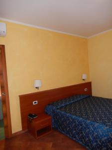 Letto o letti in una camera di Albergo Dei Leoni