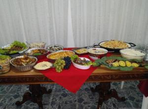 a table topped with lots of different dishes of food at Biônica Pousada in Cayru +36 photos