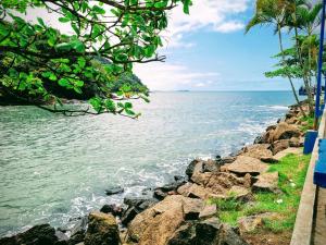 a view of the ocean from a rocky shore at Mareazul Ubatuba in Ubatuba