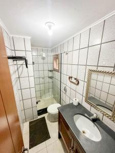 a bathroom with a sink and a toilet at Pousada Novo Horizonte in Búzios