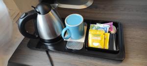 a tray with a coffee pot and a cup on a table at Chambre bleue lit individuel in Combs-la-Ville +10 photos