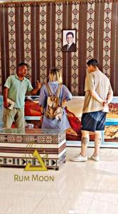 a group of people standing in front of a bed at Rum Moon Bubbles Luxury Camp in Wadi Rum