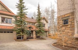 a brick house with a garage and two trees at Luxury Lodge with Breathtaking Views in Telluride