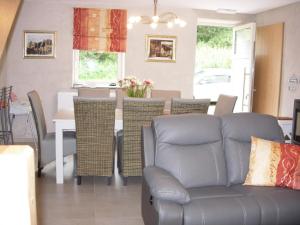 a living room with a couch and a table at Gîte rural Le Falihou (3 épis) in Braives