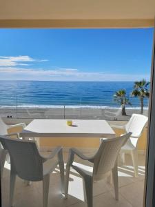 a table and chairs with a view of the ocean at Genial 1ª linea de mar Mediterráneo in Torrox